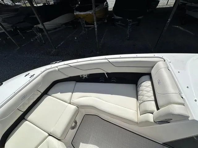 Slide: The Image of 2025 Regal LS6 boat interior with white leather seating and modern design. - 21