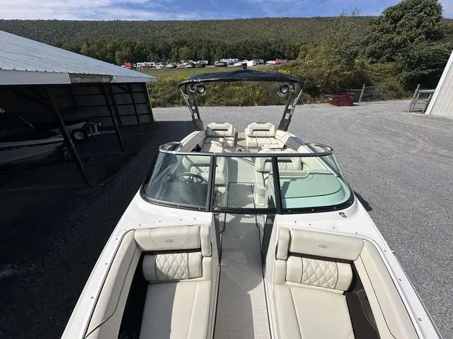 Slide: The Image of 2025 Regal LS6 boat with luxurious seating and sleek design, parked outdoors. - 22