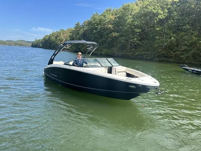 Slide: The Image of 2025 Regal LS6 boat on a serene lake with lush green trees. - 4