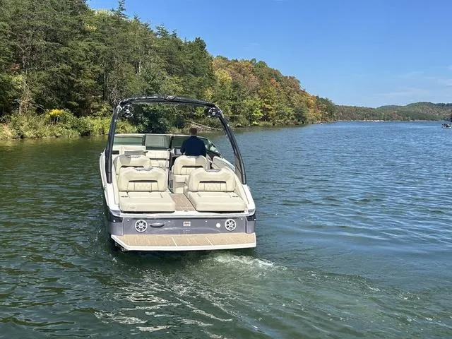 Slide: The Image of 2025 Regal LS6 boat cruising on a scenic lake with lush forest backdrop. - 5