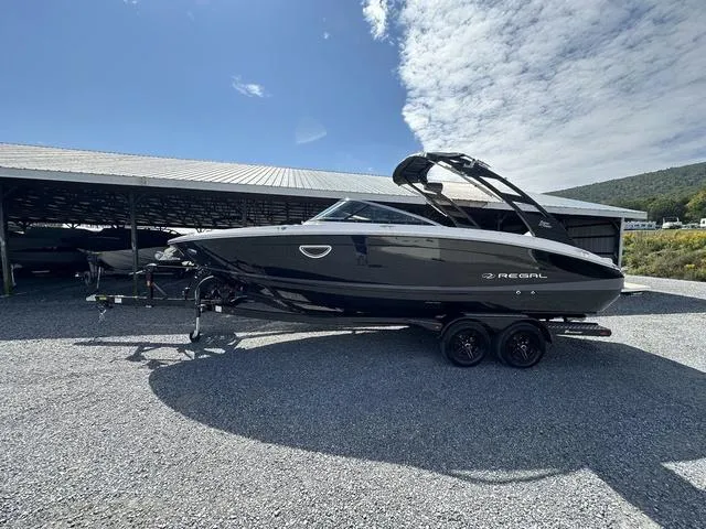 Slide: The Image of 2025 Regal LS6 boat on trailer under clear sky. - 6