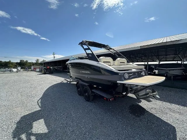 Slide: The Image of 2025 Regal LS6 boat on trailer under clear blue sky. - 8