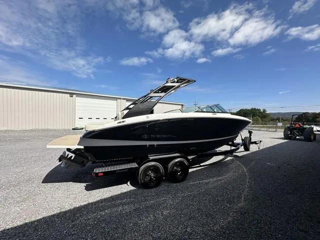 Slide: The Image of 2025 Regal LS6 boat on trailer under clear blue sky. - 9