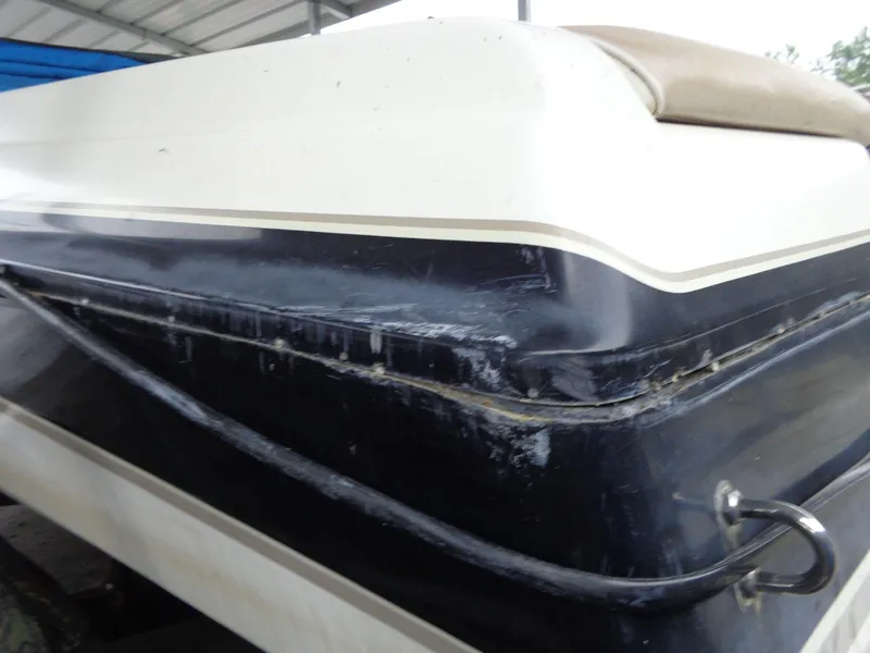 Slide: The Image of Close-up of 1998 Malibu Sunsetter VLX boat hull with visible wear. - 13