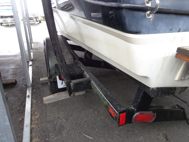 Slide: The Image of 1998 Malibu Sunsetter VLX boat on trailer, parked in storage area. - 14