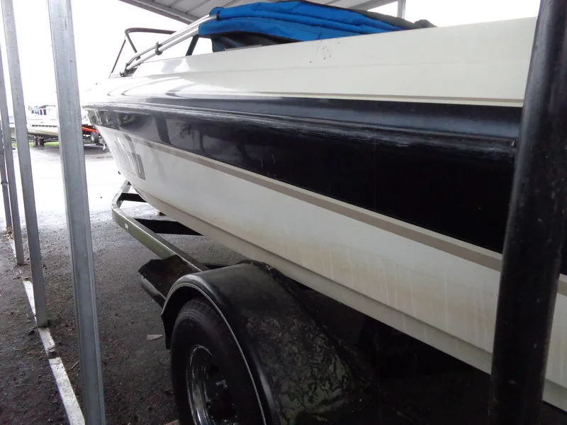 Slide: The Image of 1998 Malibu Sunsetter VLX boat on trailer under shelter. - 16
