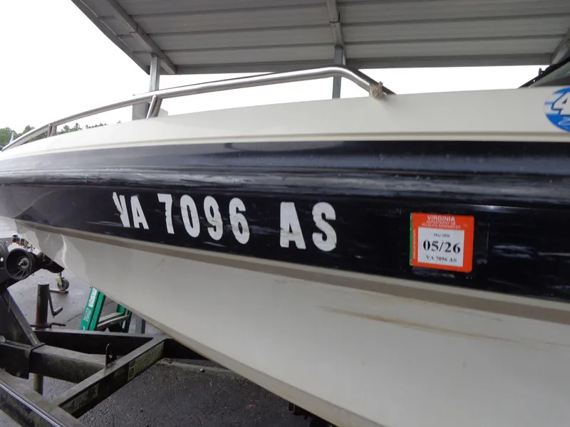 Slide: The Image of 1998 Malibu Sunsetter VLX boat with registration VA 7096 AS under a shelter. - 18