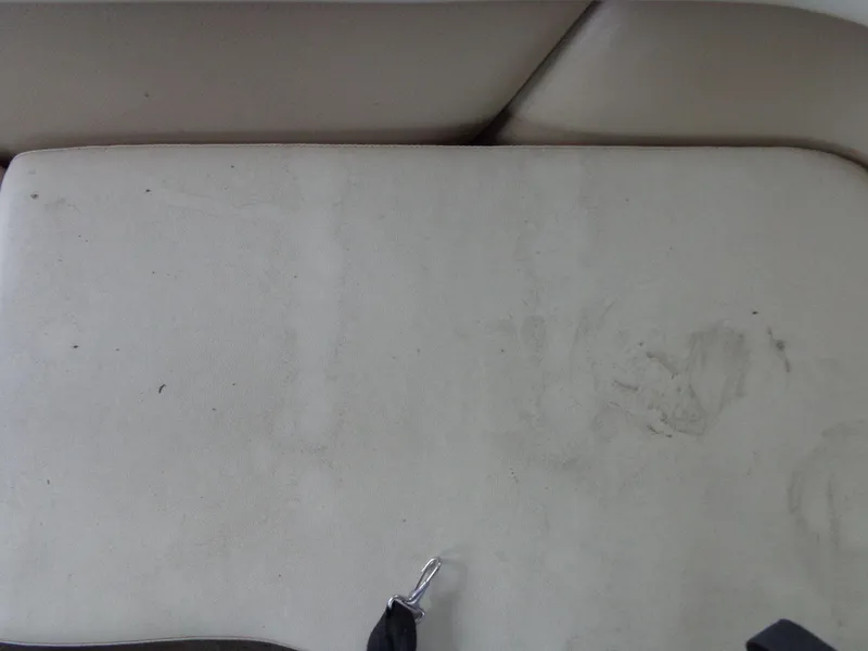 Slide: The Image of 1998 Malibu Sunsetter VLX boat interior with worn beige upholstery. - 35