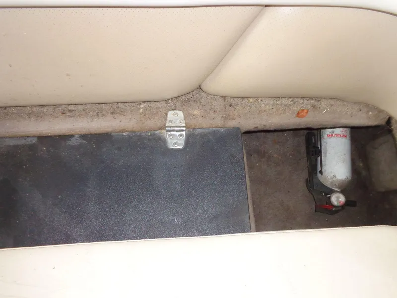 Slide: The Image of Interior of 1998 Malibu Sunsetter VLX boat with fire extinguisher and storage compartment. - 36