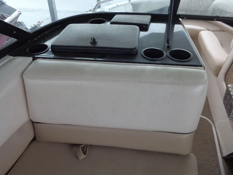 Slide: The Image of Interior of a 1998 Malibu Sunsetter VLX boat with cup holders and seating. - 41