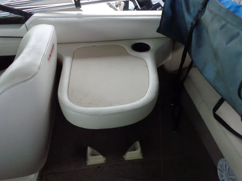 Slide: The Image of 1998 Malibu Sunsetter VLX boat interior with white seating and cup holder. - 45