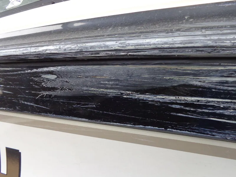 Slide: The Image of Close-up of scratched black surface on 1998 Malibu Sunsetter VLX boat. - 5