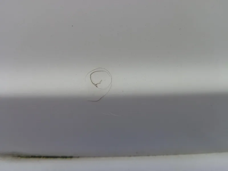 Slide: The Image of Close-up of a crack on a 2007 Sea Ray 200 Sundeck boat surface. - 16