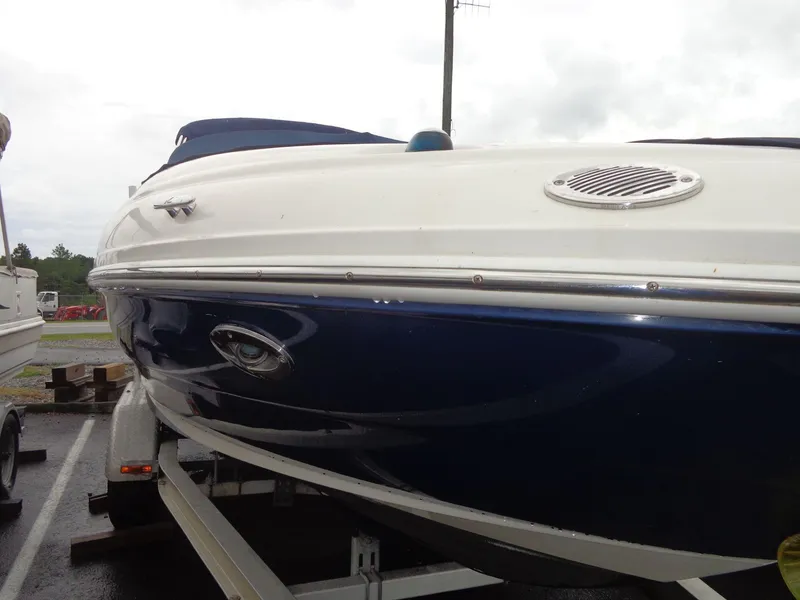 Slide: The Image of 2007 Sea Ray 200 Sundeck boat on trailer, blue and white exterior. - 3