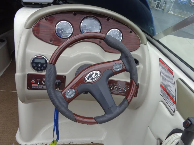 Slide: The Image of 2007 Sea Ray 200 Sundeck steering wheel and dashboard controls. - 33