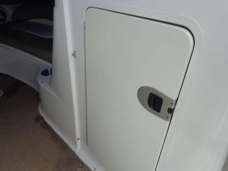 Slide: The Image of 2007 Sea Ray 200 Sundeck interior storage compartment with latch. - 39