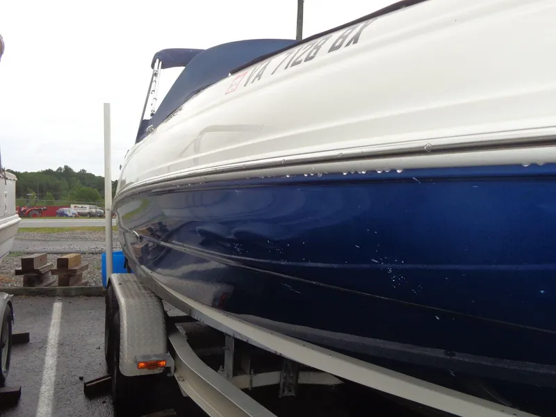Slide: The Image of 2007 Sea Ray 200 Sundeck boat on trailer, blue and white exterior. - 4