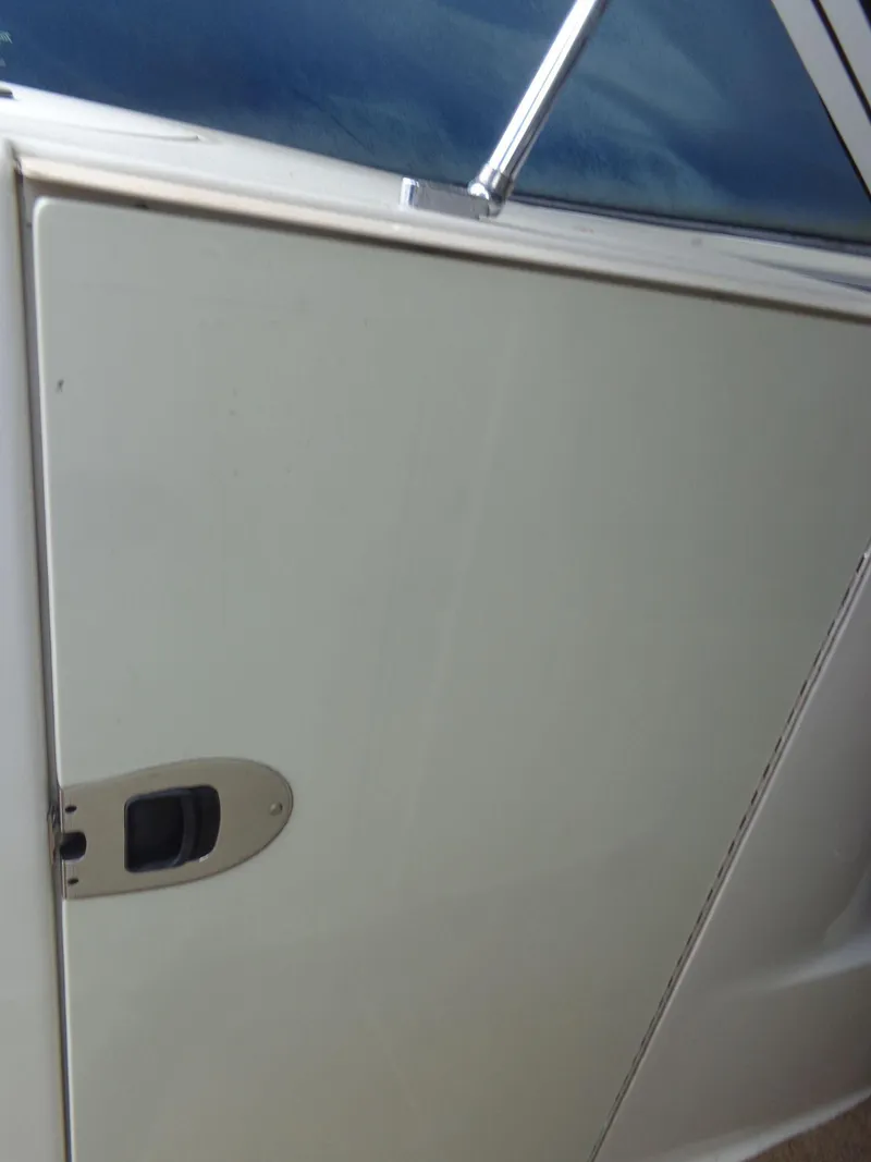 Slide: The Image of Close-up of 2007 Sea Ray 200 Sundeck boat door and window. - 41