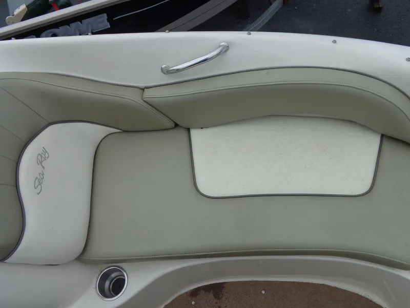 Slide: The Image of 2007 Sea Ray 200 Sundeck boat seating with beige upholstery and logo. - 43