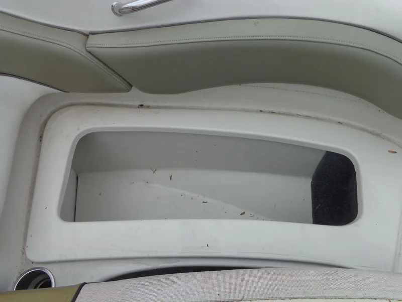 Slide: The Image of 2007 Sea Ray 200 Sundeck storage compartment with white and beige interior. - 44