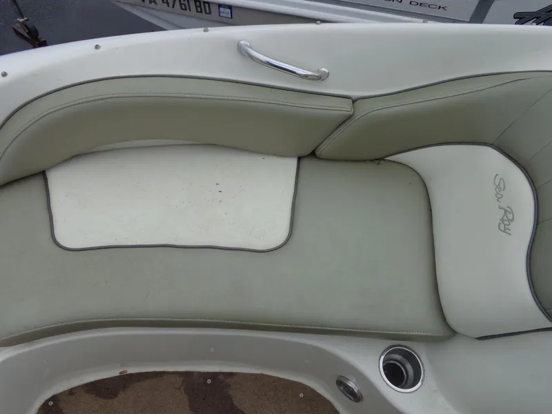 Slide: The Image of 2007 Sea Ray 200 Sundeck boat interior seating with white and gray upholstery. - 45