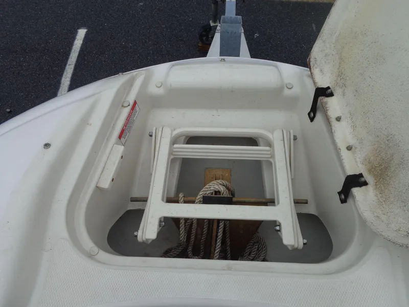 Slide: The Image of 2007 Sea Ray 200 Sundeck anchor storage compartment with ladder and ropes. - 48