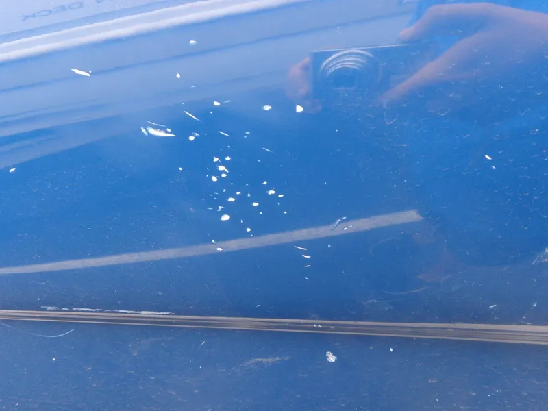 Slide: The Image of Close-up of 2007 Sea Ray 200 Sundeck blue hull with paint chips. - 5