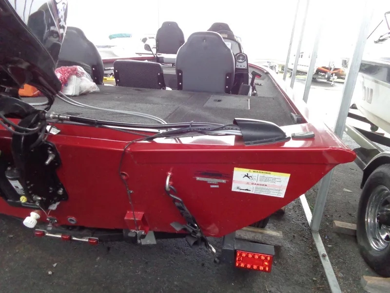 The Image of Red 2020 Lowe Stinger 175C boat, rear view, parked in a marina. - 1
