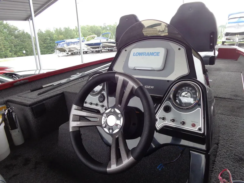 Slide: The Image of 2020 Lowe Stinger 175C boat dashboard with steering wheel and gauges. - 15