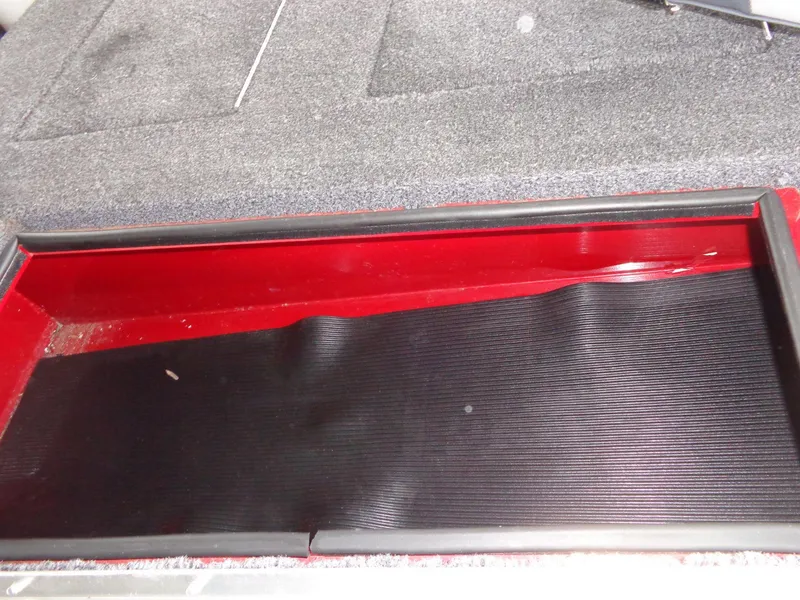 Slide: The Image of 2020 Lowe Stinger 175C boat storage compartment with red and black interior. - 20