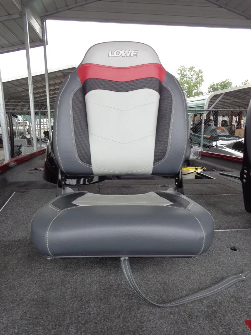 Slide: The Image of 2020 Lowe Stinger 175C boat seat, gray and red design, under covered dock. - 22