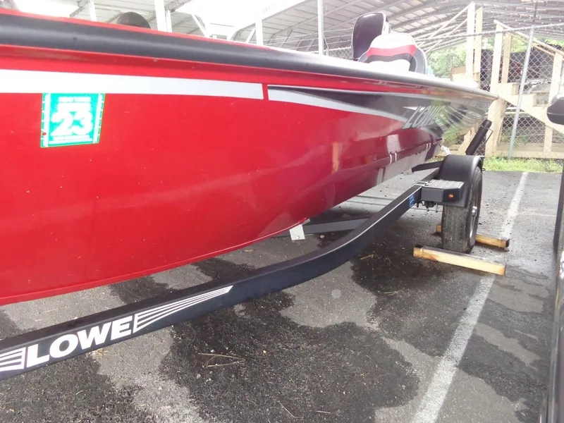 Slide: The Image of Red 2020 Lowe Stinger 175C boat on trailer, parked in covered area. - 27