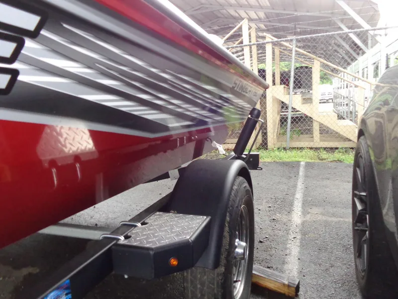 Slide: The Image of 2020 Lowe Stinger 175C boat trailer parked beside a car. - 28