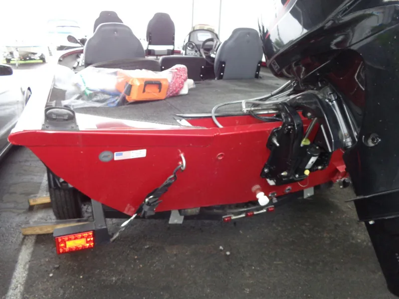 Slide: The Image of 2020 Lowe Stinger 175C boat, red exterior, parked with visible motor and interior seats. - 3