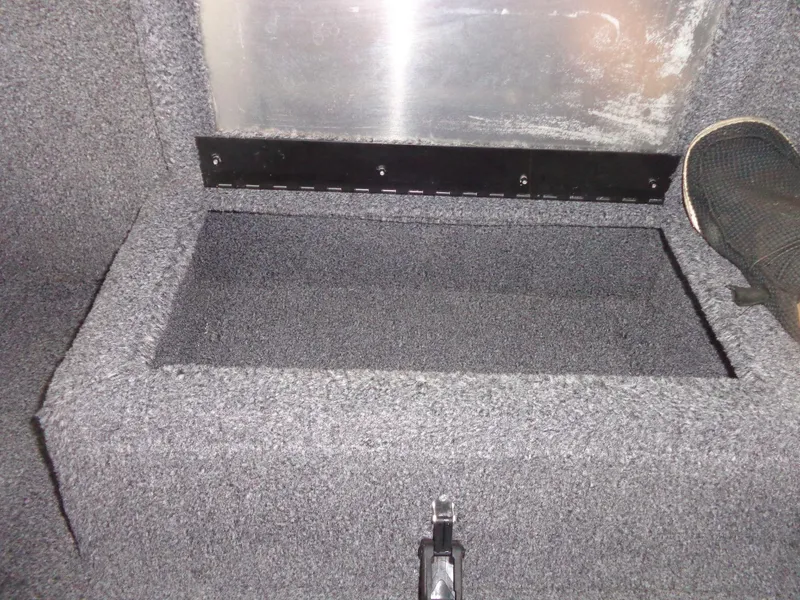 Slide: The Image of 2020 Lowe Stinger 175C boat storage compartment with carpeted interior. - 33