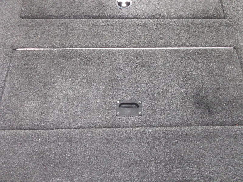 Slide: The Image of 2020 Lowe Stinger 175C boat carpeted deck with storage compartment handle. - 36