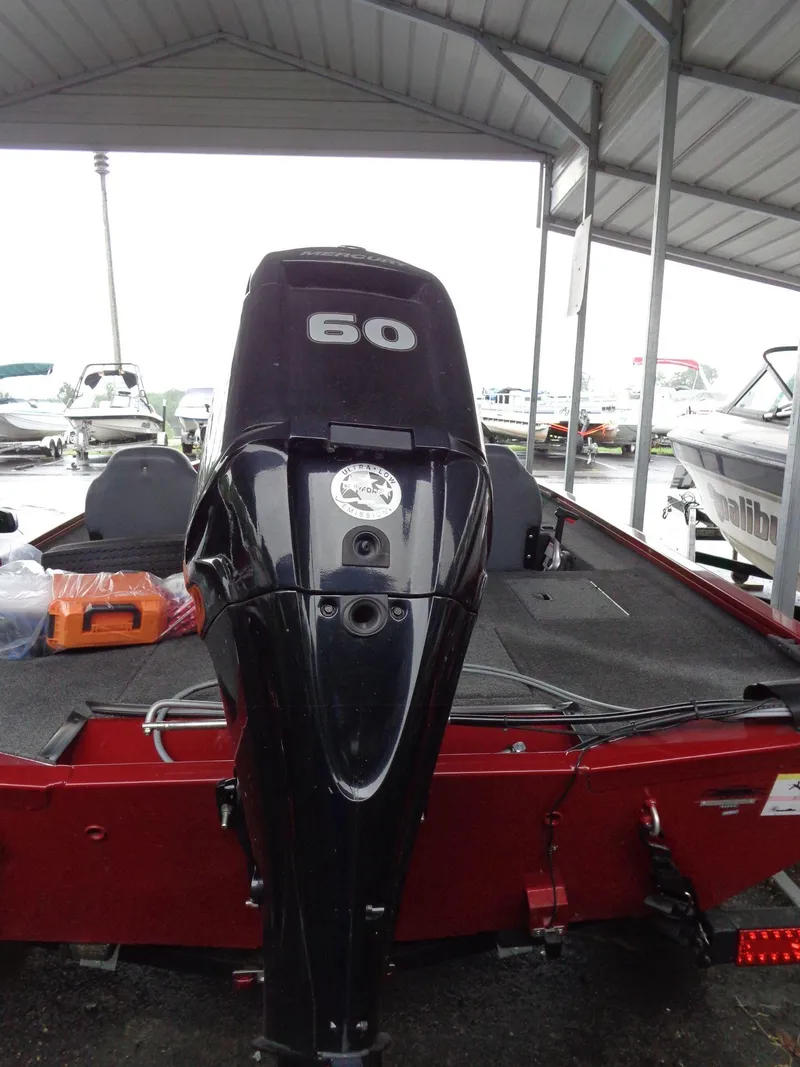 Slide: The Image of 2020 Lowe Stinger 175C boat with 60 HP outboard motor in covered dock. - 5
