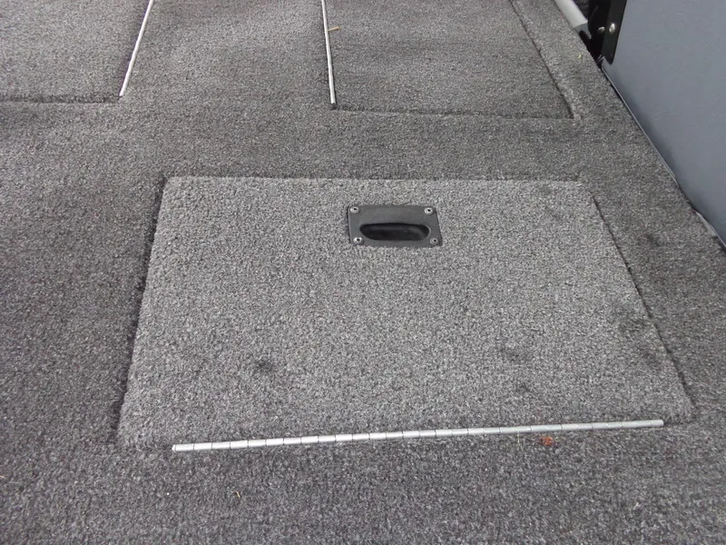 Slide: The Image of Carpeted deck of a 2020 Lowe Stinger 175C boat with storage compartment. - 9