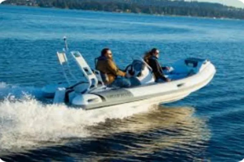 Slide: The Image of 2025 Highfield Sport 420 boat cruising on water with driver in blue jacket. - 3