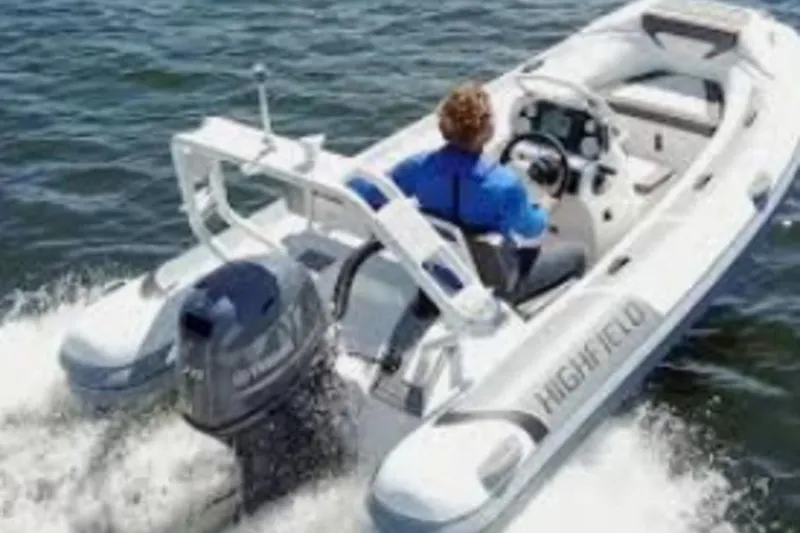 Slide: The Image of 2026 Highfield Sport460 boat cruising on water with driver in blue jacket. - 5