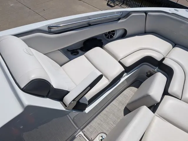 Slide: The Image of 2022 Crownline 255 SS boat interior with white cushioned seating and speaker. - 13