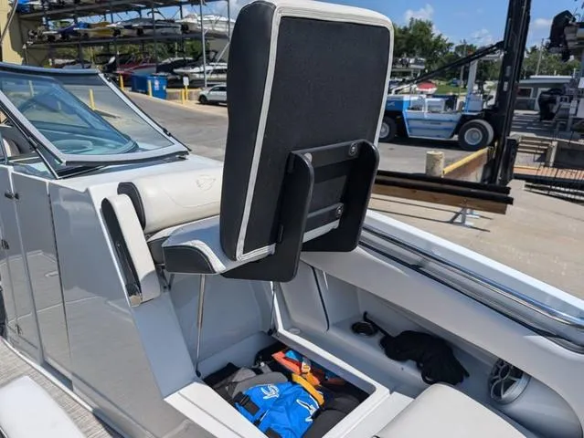 Slide: The Image of 2022 Crownline 255 SS boat interior with storage compartment and seating. - 15