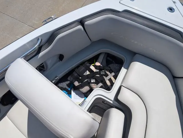 Slide: The Image of 2022 Crownline 255 SS boat interior with open storage compartment and life jackets. - 16