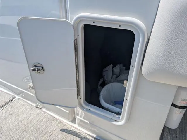 Slide: The Image of Open storage compartment on 2022 Crownline 255 SS boat. - 17