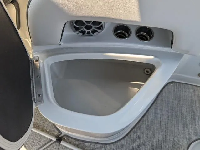 Slide: The Image of 2022 Crownline 255 SS boat storage compartment with speaker and vents. - 20