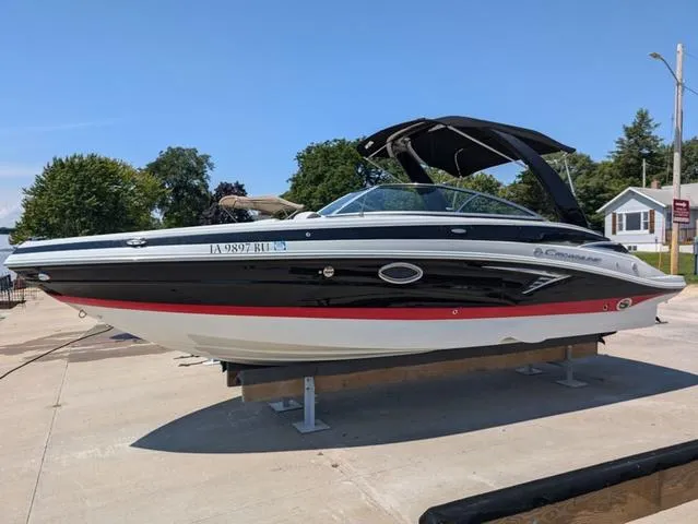 Slide: The Image of 2022 Crownline 255 SS boat on display, black and white exterior, docked on a sunny day. - 23