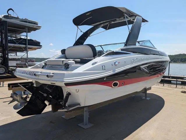 Slide: The Image of 2022 Crownline 255 SS boat with sleek design docked by the water. - 3