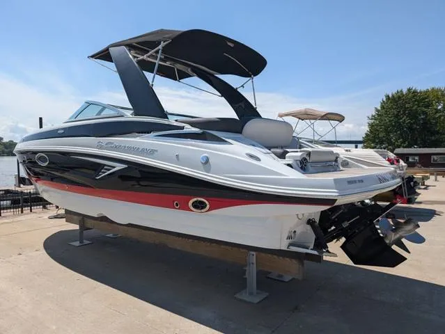 Slide: The Image of 2022 Crownline 255 SS boat with sleek design and black canopy on display. - 4