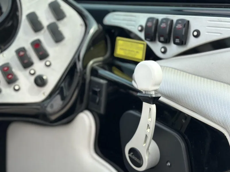 Slide: The Image of Close-up of 2016 Sanger 237LTZ boat dashboard with control lever and switches. - 12