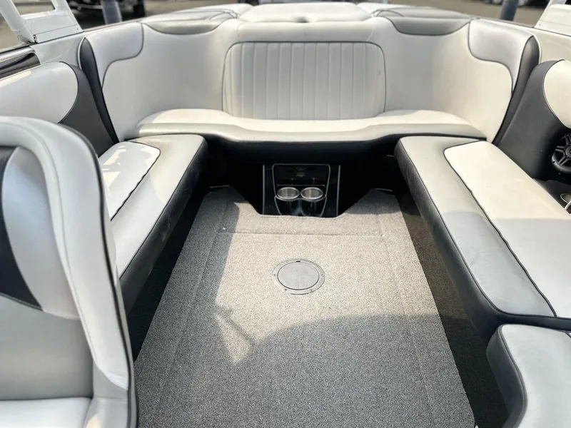 Slide: The Image of 2016 Sanger 237LTZ boat interior with gray and white seating and cup holders. - 13